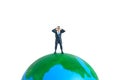 Businessmen standing using binoculars above earth globe. Miniature tiny people toys photography. isolated on white background Royalty Free Stock Photo