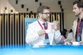 Businessmen talking during coffee break at lobby of convention center