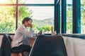 Businessmen are thinking,wearing glasses and smiling, as he works on his laptop to get all his business done early in the morning Royalty Free Stock Photo