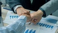 Businessmen tie together during a meeting after signing a deal and a successful business partnership. Royalty Free Stock Photo