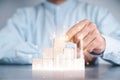 Businessmen use a handle on the wooden block to show stock graphs and rising stock signals with chart indicators. Concepts of
