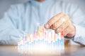Businessmen use a handle on the wooden block to show stock graphs and rising stock signals with chart indicators. Concepts of