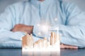 Businessmen use a handle on the wooden block to show stock graphs and rising stock signals with chart indicators. Concepts of