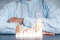 Businessmen use a handle on the wooden block to show stock graphs and rising stock signals with chart indicators. Concepts of