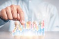Businessmen use a handle on the wooden block to show stock graphs and rising stock signals with chart indicators. Concepts of