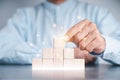 Businessmen use a handle on the wooden block to show stock graphs and rising stock signals with chart indicators. Concepts of