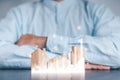 Businessmen use a handle on the wooden block to show stock graphs and rising stock signals with chart indicators. Concepts of