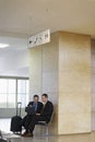 Businessmen Using Laptop In Airport