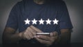 Businessmen is using smart phones to give a 5 star symbol to increase rating