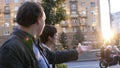 Businessmen walking and talking on street discussing work outdoor, tracking shot.