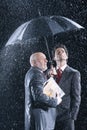 Businessmen Watching Rain From Under Umbrella Royalty Free Stock Photo