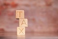 Businessmen wear a white shirt at their desks in the office. Use your hand to pick up a wooden cube inscribed with the word tax