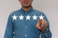 Businessmen wearing a light blue shirt to selecting the level of satisfaction score icons with copy space. Customer service