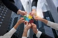 Businessmen working together to build a puzzle as teamwork, partnership and integration concept Royalty Free Stock Photo