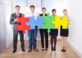 Businesspeople assembling jigsaw puzzle Royalty Free Stock Photo