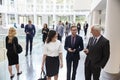 Businesspeople In Busy Lobby Area Of Modern Office Royalty Free Stock Photo