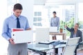 Businesspeople carrying their belongings in box