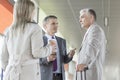 Businesspeople communicating on railroad platform