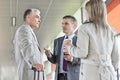 Businesspeople communicating on railroad platform