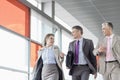 Businesspeople communicating while walking on railroad platform