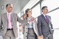 Businesspeople communicating while walking on train platform