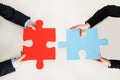 Businesspeople Connecting Puzzle Pieces