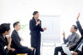 Businesspeople discussing at conference, businesswoman speaker holding microphone while lecturing presentation at group board. Royalty Free Stock Photo