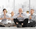 Businesspeople doing meditation in office