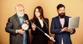 Businesspeople. dream team. bearded man with laptop and alarm clock. mature men and sexy girl with bat. deadline concept Royalty Free Stock Photo