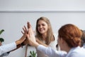 Businesspeople giving high five showing respect and togetherness