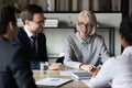 Businesspeople group diverse gender generation hold negotiations at conference table