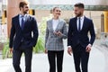 Businesspeople group walking at modern bright office interior Royalty Free Stock Photo