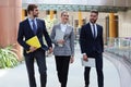 Businesspeople group walking at modern bright office interior Royalty Free Stock Photo