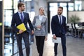 businesspeople group walking at modern bright office interior. Royalty Free Stock Photo