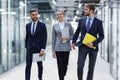 businesspeople group walking at modern bright office interior. Royalty Free Stock Photo