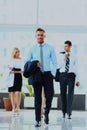 Businesspeople group walking at modern bright office interior. Royalty Free Stock Photo