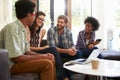 Businesspeople Having Informal Meeting In Modern Office