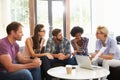 Businesspeople Having Informal Meeting In Modern Office