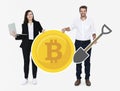 Businesspeople holding bitcoin cryptocurrency and mining concept icons