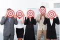 Businesspeople Holding Dartboard