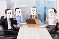 Businesspeople holding question mark sign