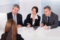 Businesspeople interviewing woman