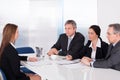 Businesspeople interviewing woman