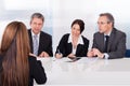 Businesspeople interviewing woman