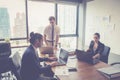 Businesspeople with leader discussing together in conference room during meeting at office. Royalty Free Stock Photo