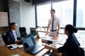 Businesspeople with leader discussing together in conference room. Royalty Free Stock Photo