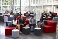 Businesspeople Meeting In Busy Lobby Of Modern Office Royalty Free Stock Photo