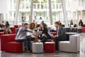 Businesspeople Meeting In Busy Lobby Of Modern Office Royalty Free Stock Photo