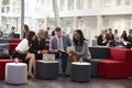 Businesspeople Meeting In Busy Lobby Of Modern Office Royalty Free Stock Photo