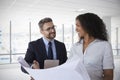 Businesspeople Meeting To Look At Plans In Empty Office Royalty Free Stock Photo